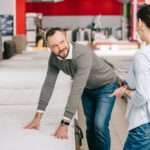 couple choosing mattress together in furniture shop