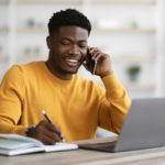 Happy black man freelancer working from home