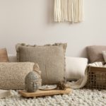 The stylish composition of meditation living room interior with beige carpet, pillows,